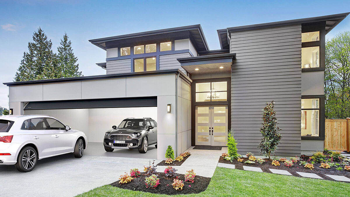 Breiter, schöner, komfortabler: Moderne Garagentore sind längst Teil der Architektur. Der Antrieb ist heute Standard, oft ist er eingebunden in Smart-Home-Konzepte. 