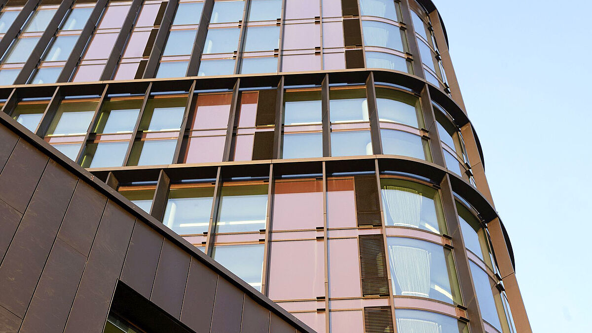 Les façades sont structurées par les formats de fenêtres, qui soulignent eux aussi la verticalité. Elles donnent une impression de relief et de profondeur, perceptible sous tous les angles. Les lamelles verticales en cuivre soulignent cette structure de façade dynamique. 